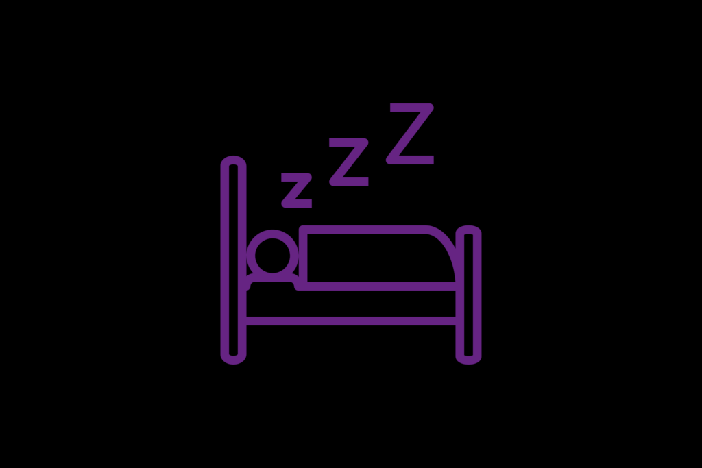A person lying in bed with their eyes closed, surrounded by soft lighting, symbolizing the importance of rest and sensory calm in autistic happiness.